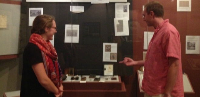 Intern shows interested museum goer new exhibit